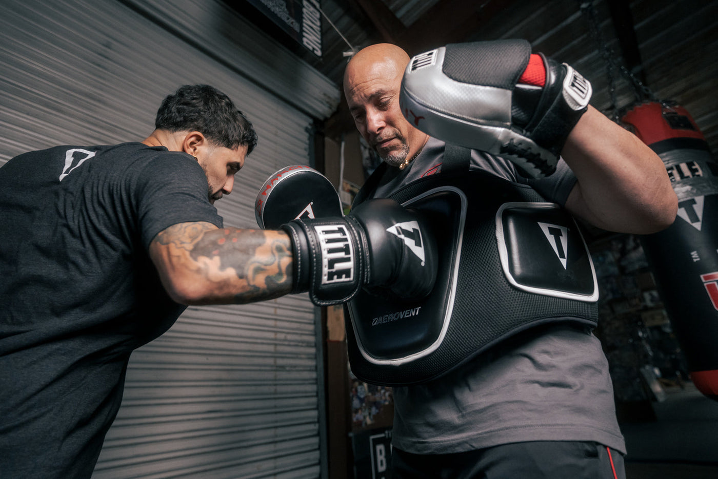 variant:lifestyle::TITLE Boxing Aerovent Elite Body Protector guy hitting protector