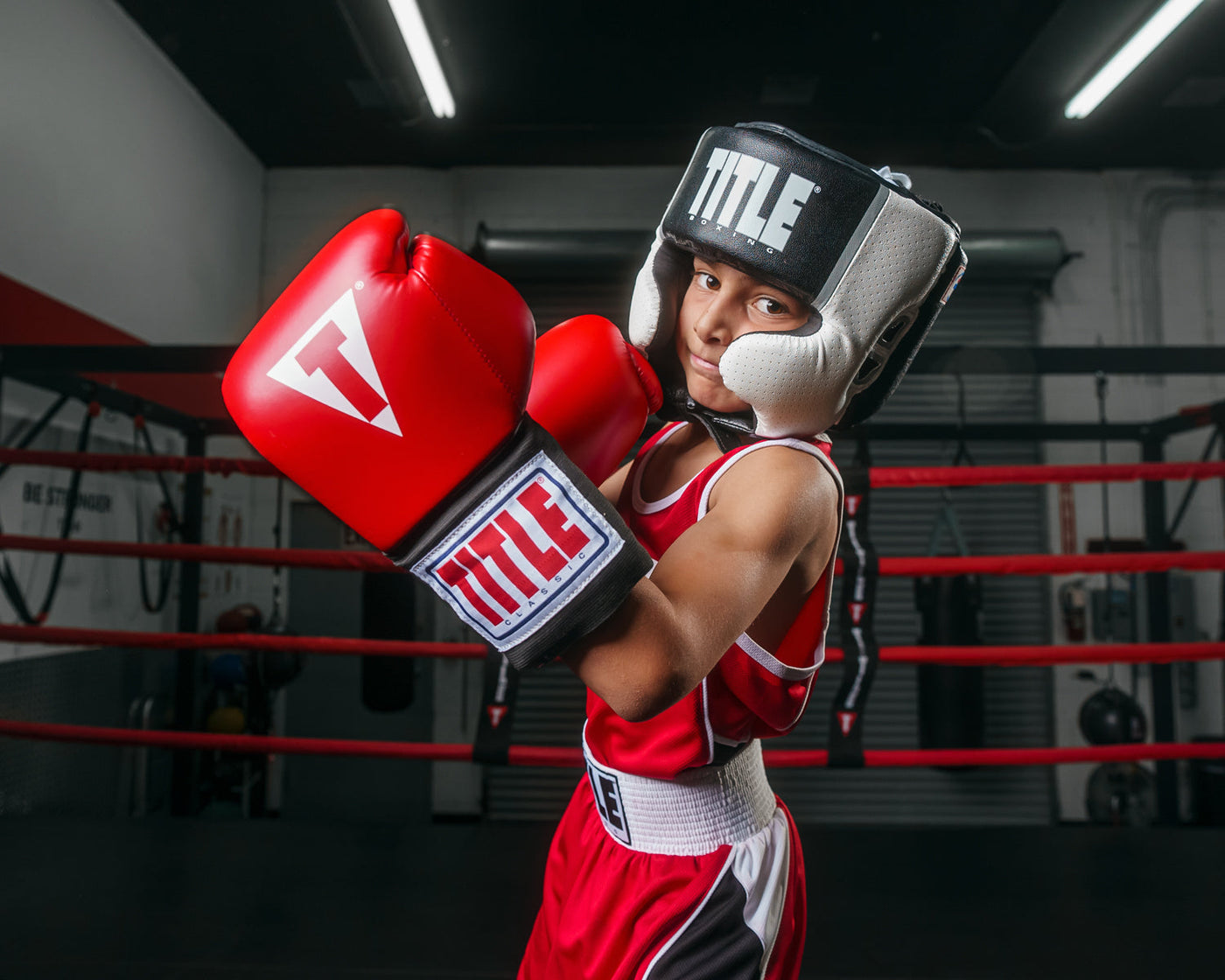 variant:black::TITLE Boxing Aerovent Elite USA Boxing Competition Headgear – Open Face kid throwing left uppercut