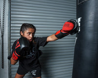 variant:black/red::TITLE Boxing All Heart Bag Gloves 2.0 girl jabbing bag