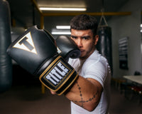 variant:black/white::TITLE Boxeo Mexican Leather Bag Gloves Quatro guy punching stance