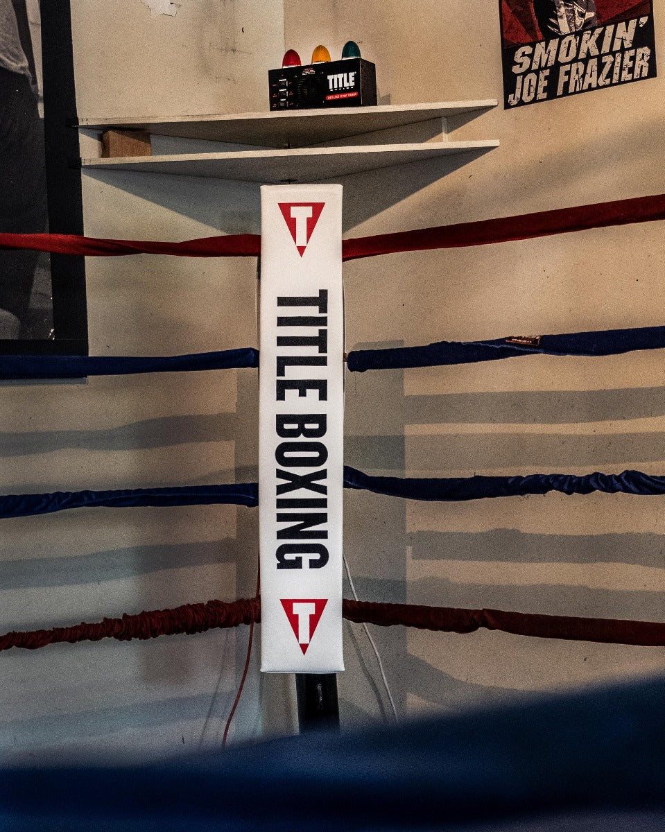 variant:lifestyle::TITLE Boxing Deluxe Gym Timer next to a boxing ring