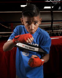 variant:Y::TITLE Boxing Elbows In Trainer youth size being used by child boxer