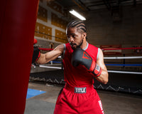 variant:lifestyle::TITLE Boxing Guts and Glory Bag Gloves man striking bag