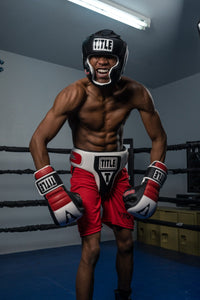 variant:Black::TITLE Boxing Gel World Full Face Training Headgear man posing with headgear