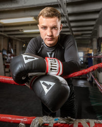variant:Black::TITLE Boxing Gel World Bag Gloves man posing with gloves