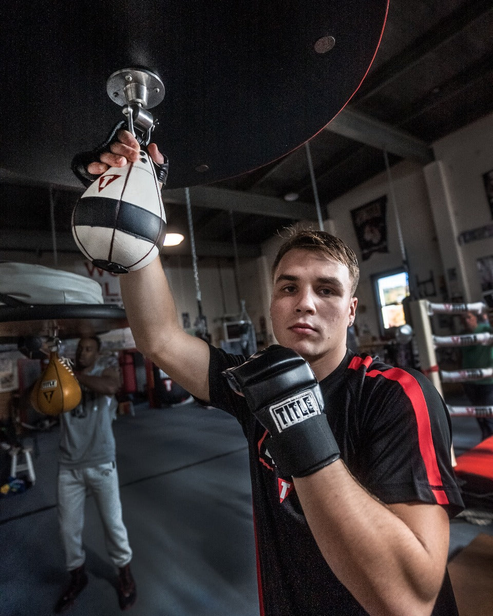 variant:lifestyle::TITLE Boxing Lightning Fast Speed Bag guy holding bag