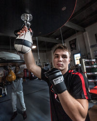 variant:lifestyle::TITLE Boxing Lightning Fast Speed Bag guy holding bag