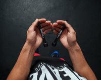 variant:lifestyle::TITLE Boxing Licorice Speed Rope 2.0 guy holding jump rope handles