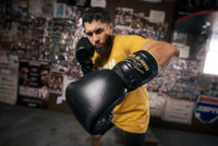 variant:lifestyle::TITLE Boxing Roberto Duran Leather Sparring Gloves guy posing with boxing gloves