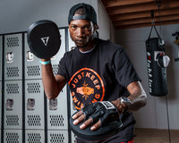 variant:lifestyle::TITLE Boxing Razor Punch Mitts 2.0 guy posing with punch mitts