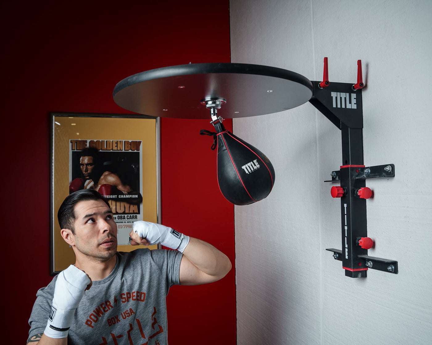 variant:lifestyle::TITLE Fold-Away Adjustable Speed Bag Platform 2.0 guy punching speedbag