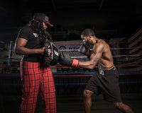 variant:lifestyle::TITLE Boxing Tombstone Training Shield guy hitting training shield 