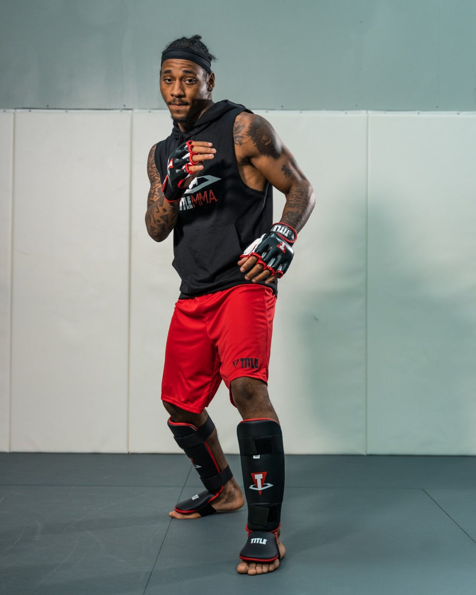 variant:lifestyle::TITLE MMA Conflict Stand Up Shin Guards man posing in shin guards